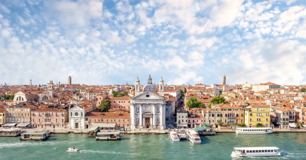 A panoramic view of Venice, showcasing historic architecture and canals, one of the best places to stay in Italy.