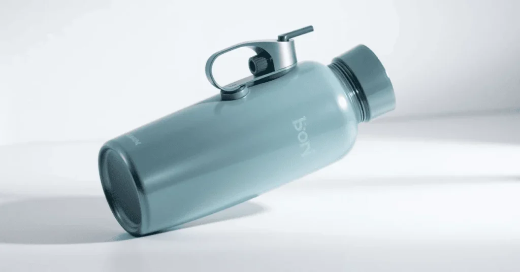 A sleek, light blue HydroJug Traveler water bottle lying on its side, showcasing its durable design and convenient handle.