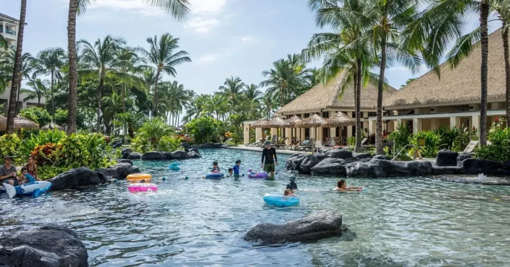 Best places to visit in August, featuring families playing in the water in Hawaii.