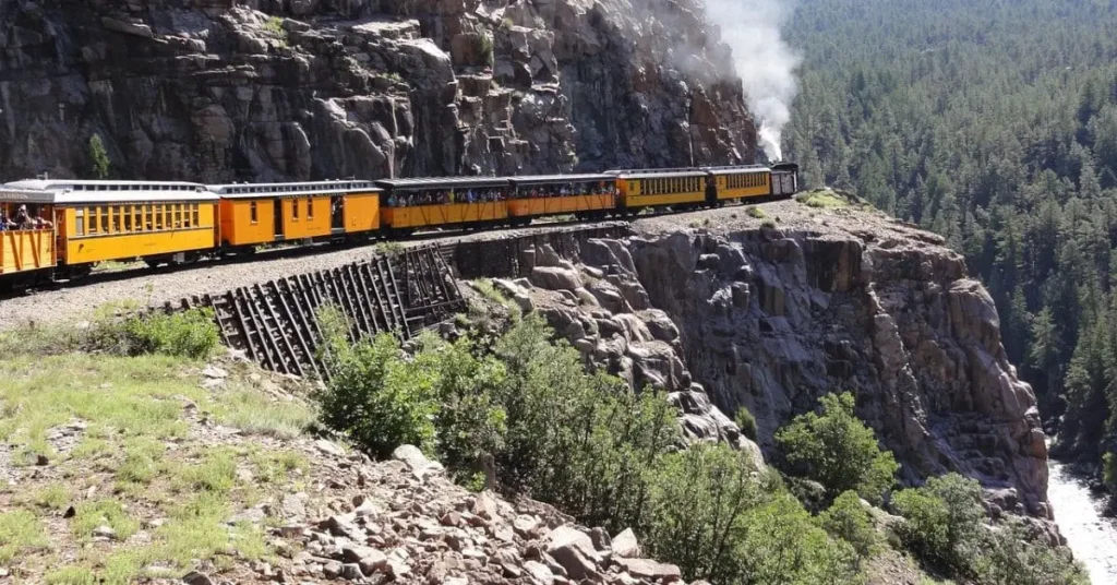 Historic train ride showcasing the best things to do in Durango CO, with scenic cliffs and lush forests.