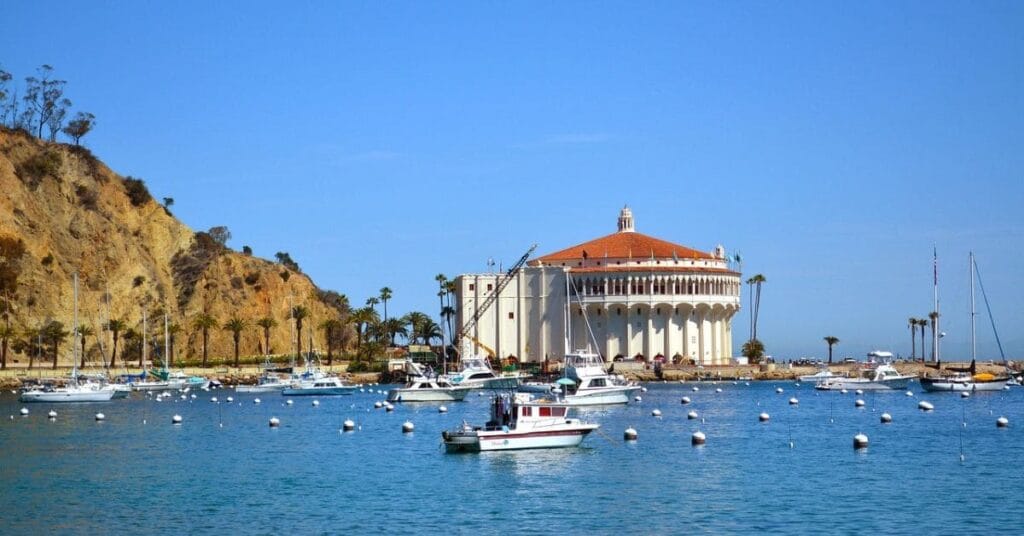 A scenic view of Catalina Island's Avalon Harbor, featuring the historic Casino Building.