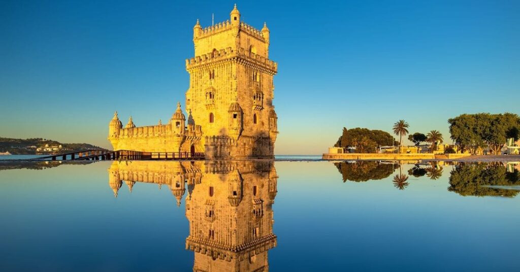 A traveler's dream destination: a historic tower reflecting on calm water, one of the cheapest travel destinations January.