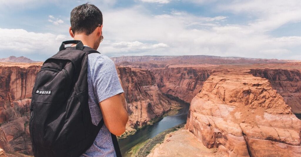 A man wearing a durable travel backpack, ideal for practical and stylish travel gifts for men.