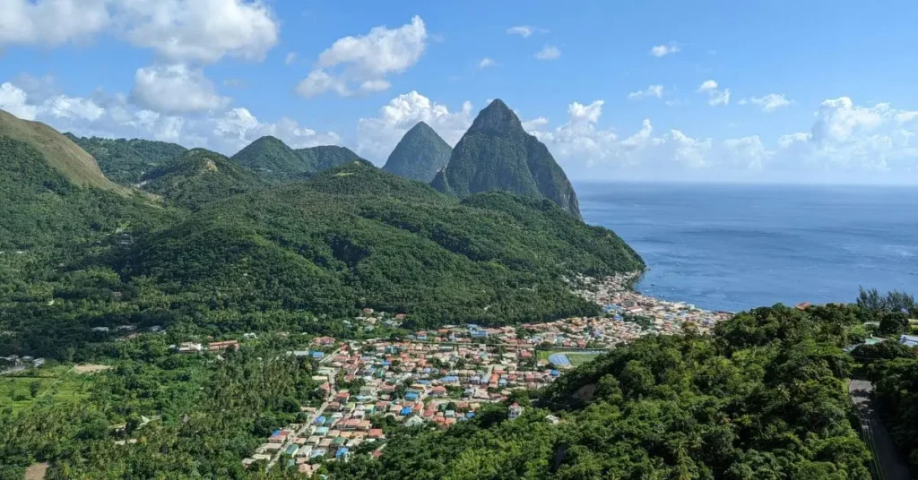 The Pitons, iconic volcanic spires in St. Lucia, overlooking the town of Soufrière, a breathtaking sight and a key factor to consider when determining the best time to visit St Lucia for sightseeing and outdoor activities.