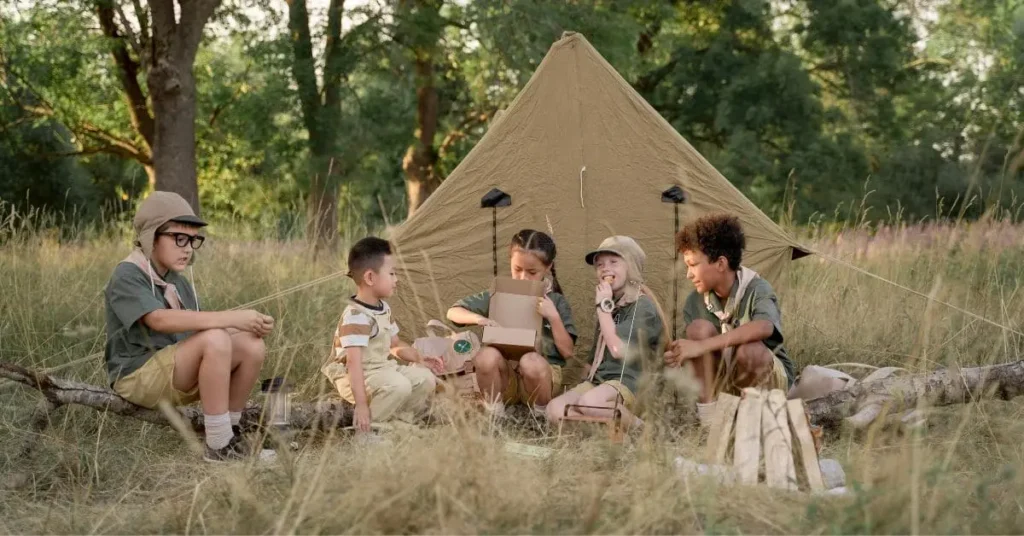 Children enjoying outdoor activities near a tent, representing the camaraderie and adventure associated with scouting related places to visit in Japan.