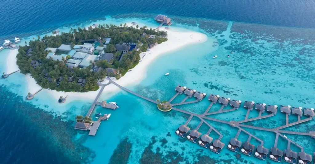 Experience luxury at a tropical resort: While this image showcases the Maldives, it evokes the allure of island getaways, prompting thoughts of planning the best time to visit Tahiti for a similar paradise experience.