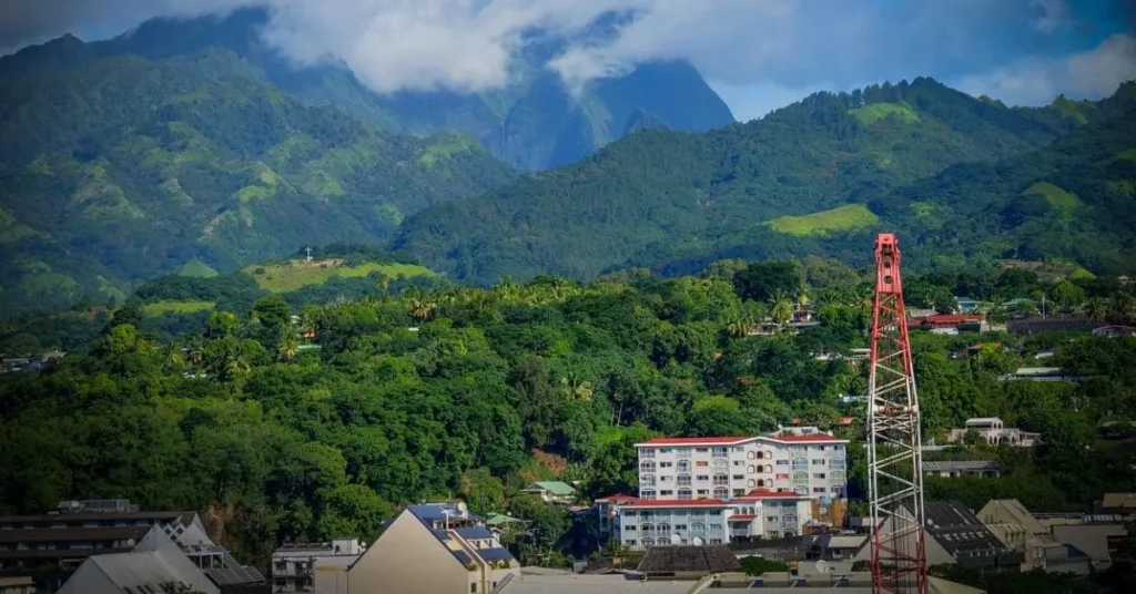 Discover the lush beauty of Tahiti: A vibrant cityscape nestled amidst verdant, mountainous terrain, showcasing the allure of this South Pacific paradise and hinting at the best time to visit Tahiti for ideal weather.