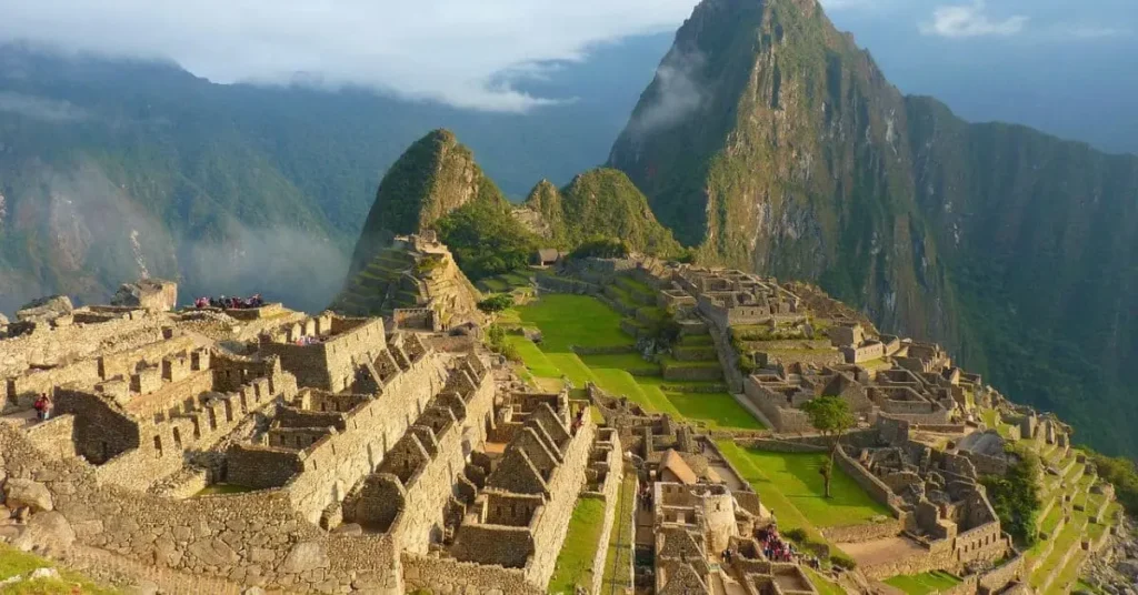 Stunning view of Machu Picchu, one of the must-visit places in Peru, with ancient Incan ruins set against the backdrop of misty mountains.